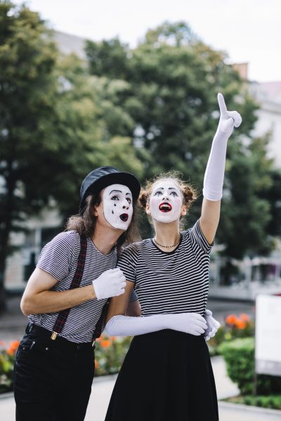 female-mime-pointing-upwards-showing-something-male-mime