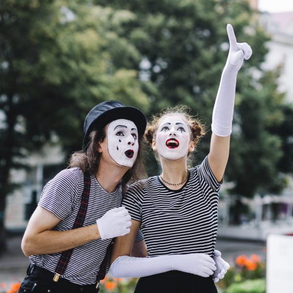 female-mime-pointing-upwards-showing-something-male-mime
